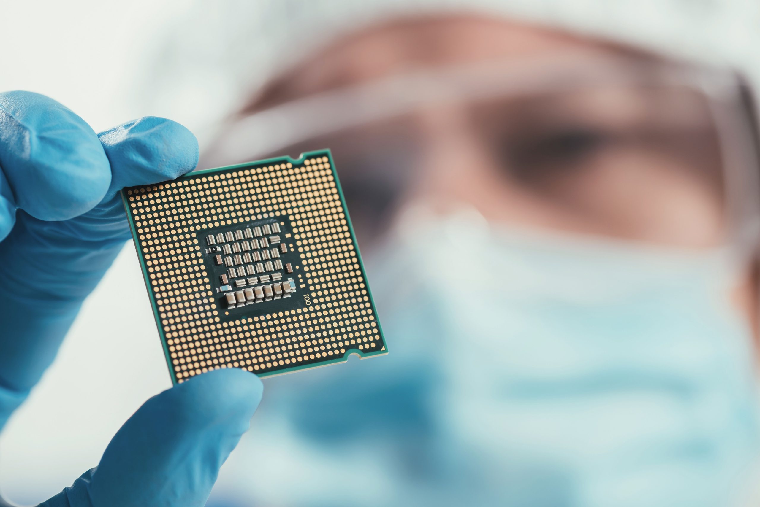 selective focus of engineer holding computer microchip